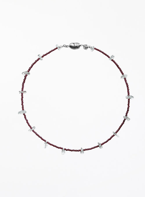 red necklace and small white beads on a white background