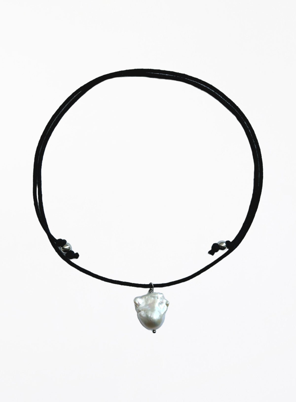 black cord necklace with baroque pearl in the center against white background