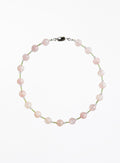 Necklace with pink and green beads beads on a white background