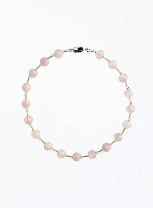 Necklace with pink and green beads beads on a white background