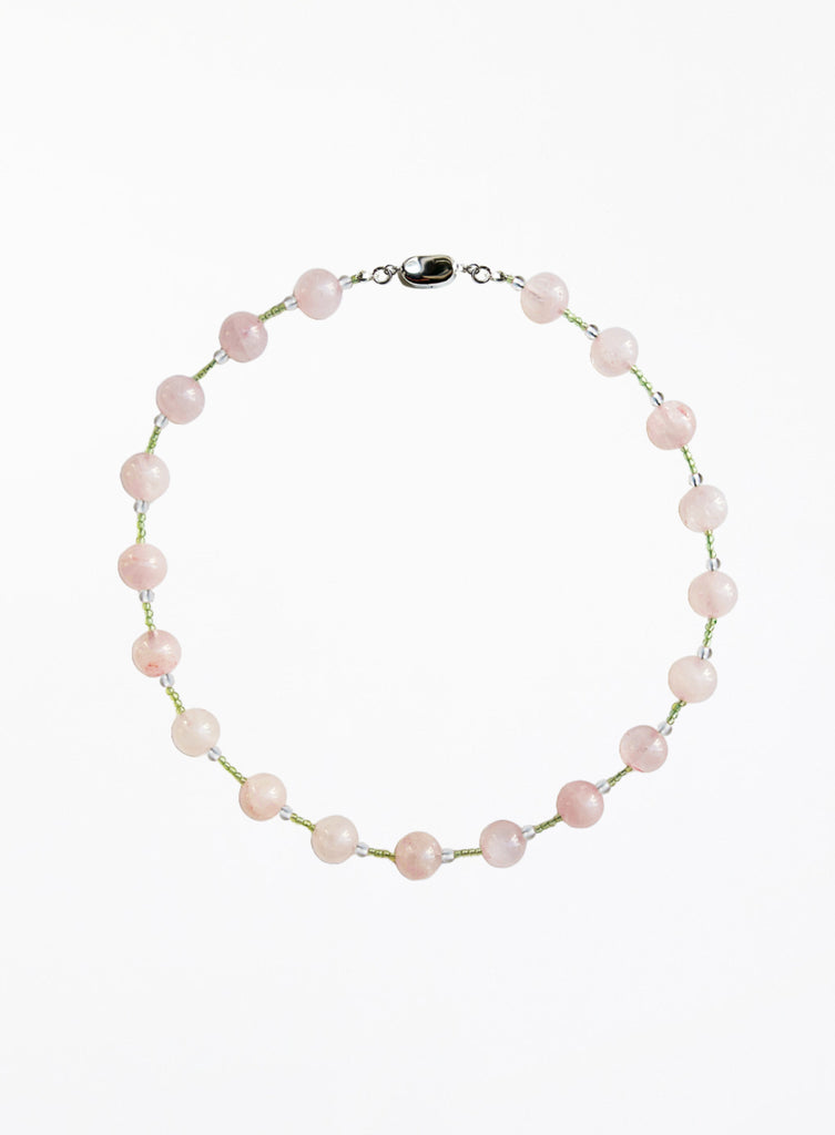 Necklace with pink and green beads beads on a white background