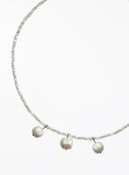 Necklace with three cultured pearl beads on a white background