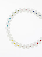 white jade beaded bracelet with multicolored accents on a white background