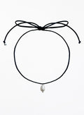 Black choker necklace with a pearl pendant on a white background