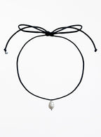 Black choker necklace with a pearl pendant on a white background