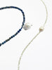 Two necklaces, one with blue beads and white pearls, the other with white beads and pearls, on a white background.
