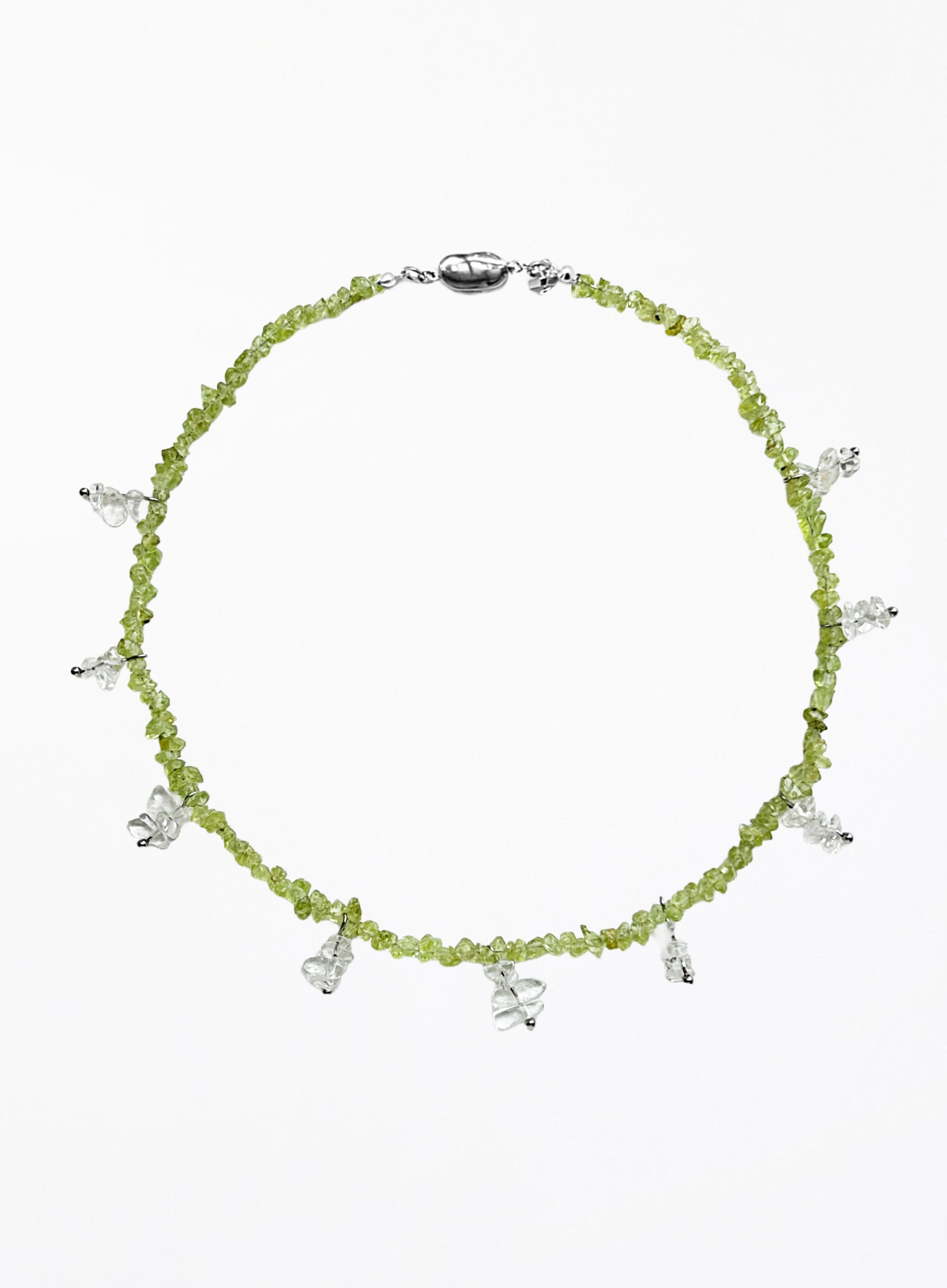 Necklace with green beads and white beaded charms on a white background