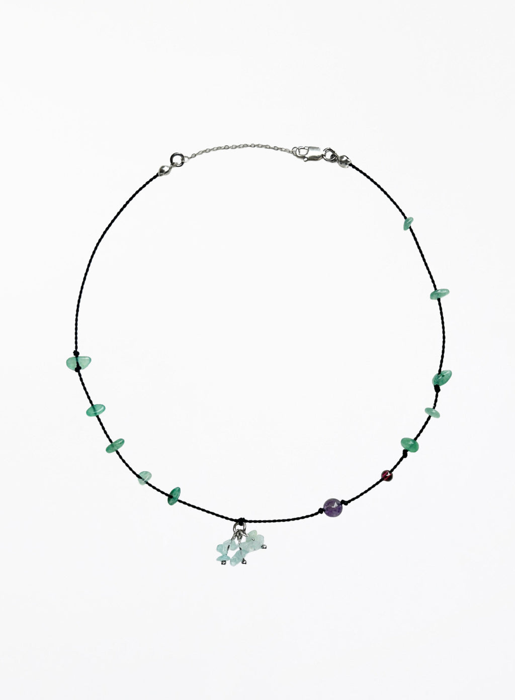 Necklace with green beads and a small charm on a white background