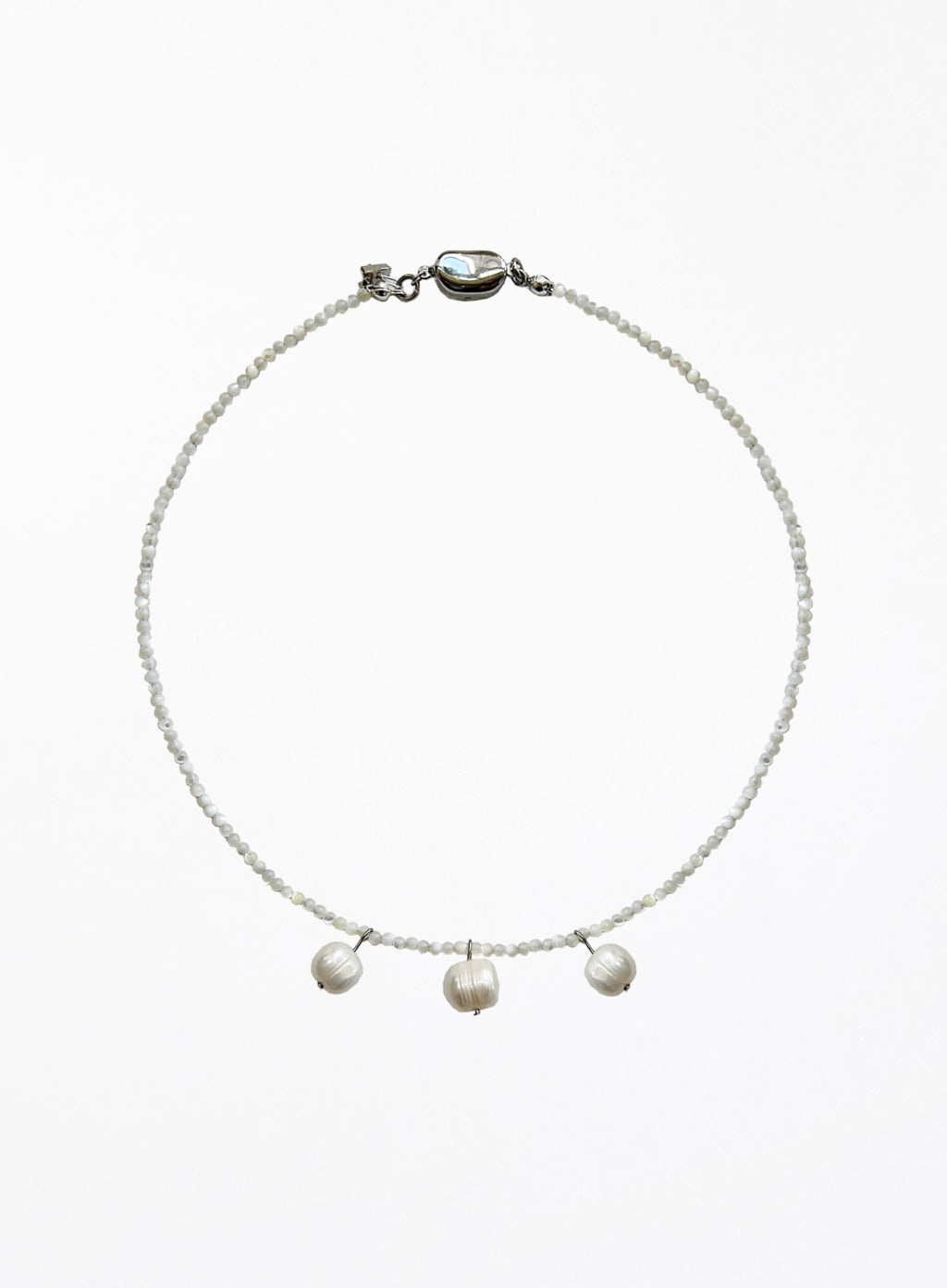 Necklace with three cultured pearl beads on a white background