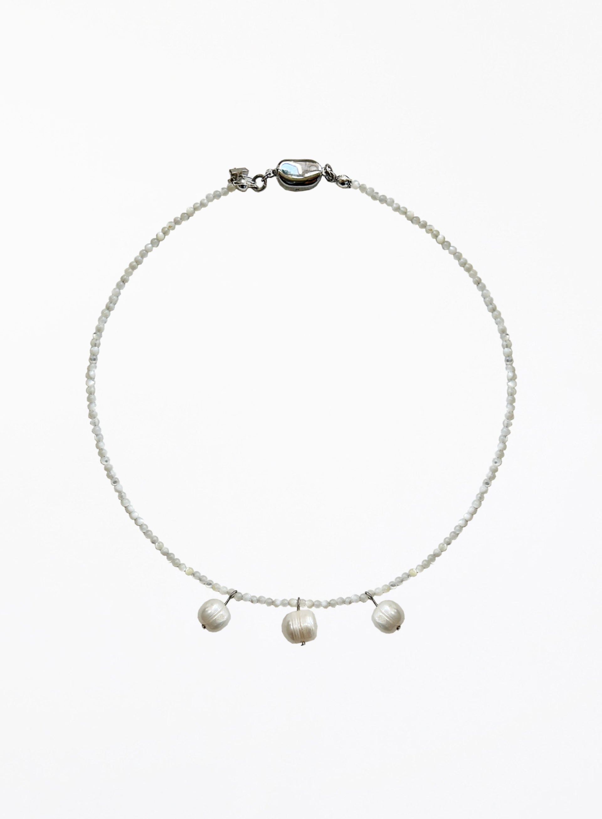 Necklace with three cultured pearl beads on a white background