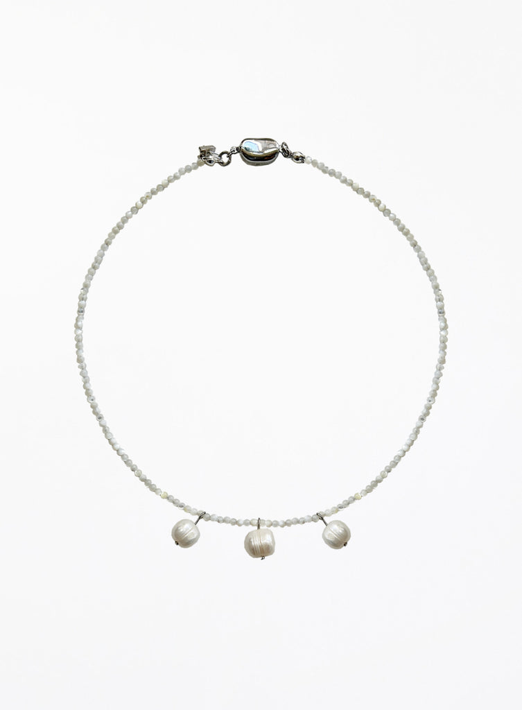 Necklace with three cultured pearl beads on a white background