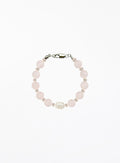 Bracelet with rose quartz beads and solo pearl on a white background
