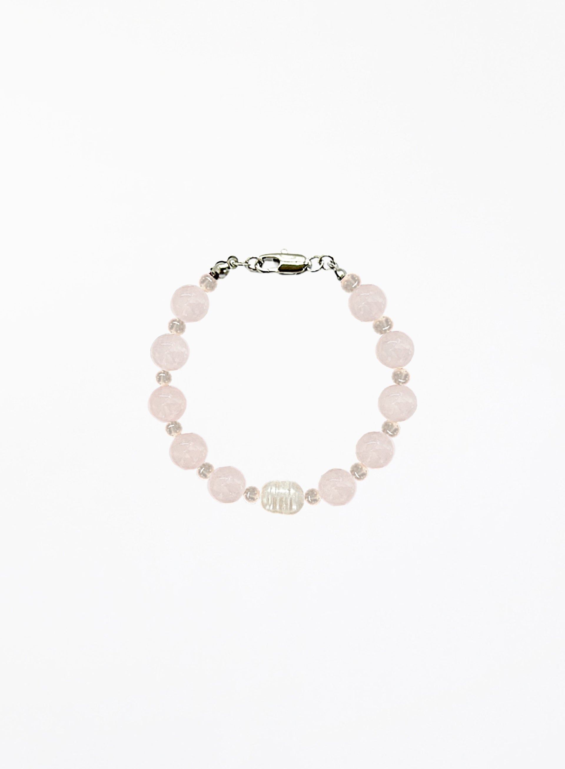 Bracelet with rose quartz beads and solo pearl on a white background