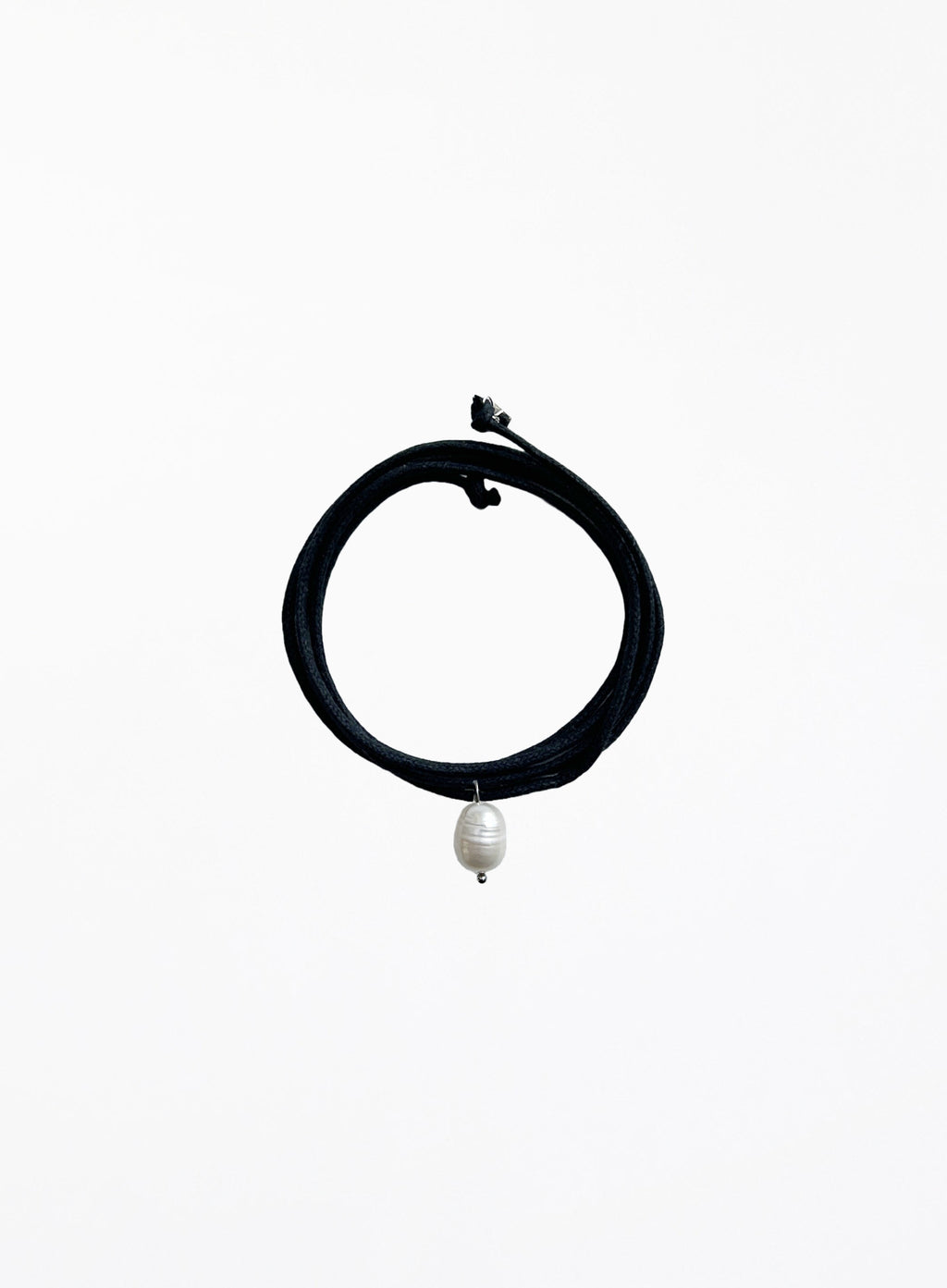 Black choker necklace with a pearl pendant on a white background