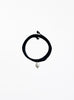 Black choker necklace with a pearl pendant on a white background