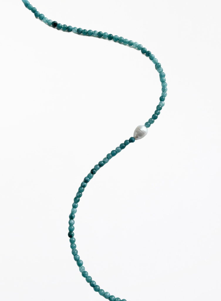 Turquoise beaded necklace with a pearl pendant on a white background