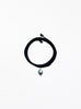Black choker necklace with a pearl pendant on a white background