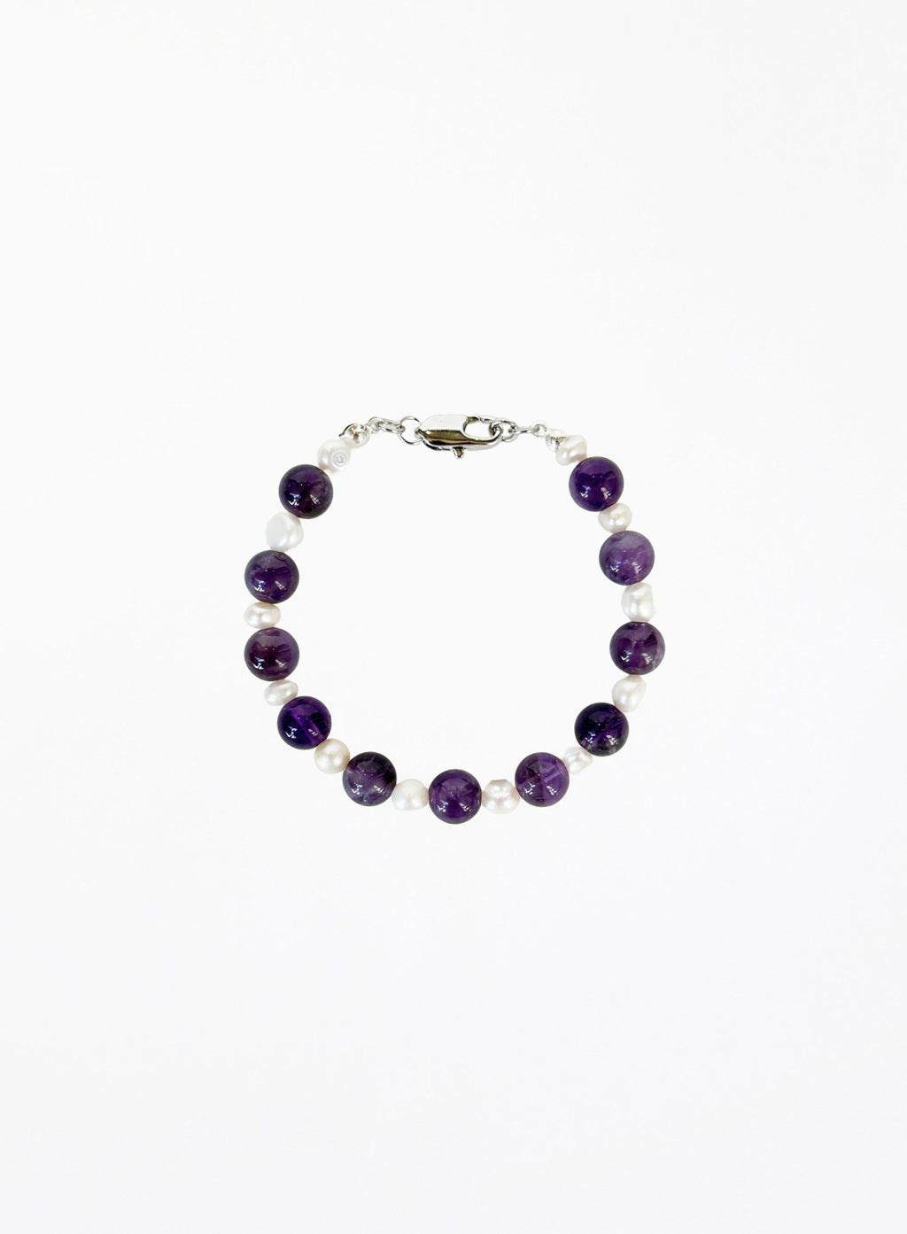 Bracelet with amethyst beads and pearls with silver clasp on a white background
