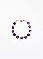 Bracelet with amethyst beads and pearls with silver clasp on a white background