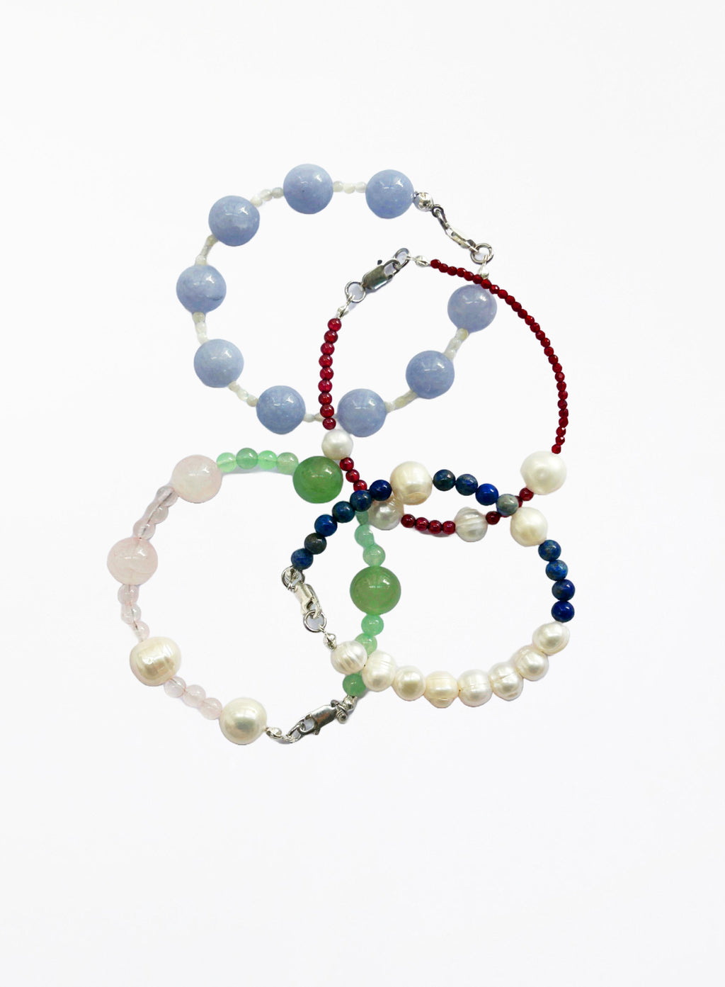 Set of four beaded bracelets on a white background