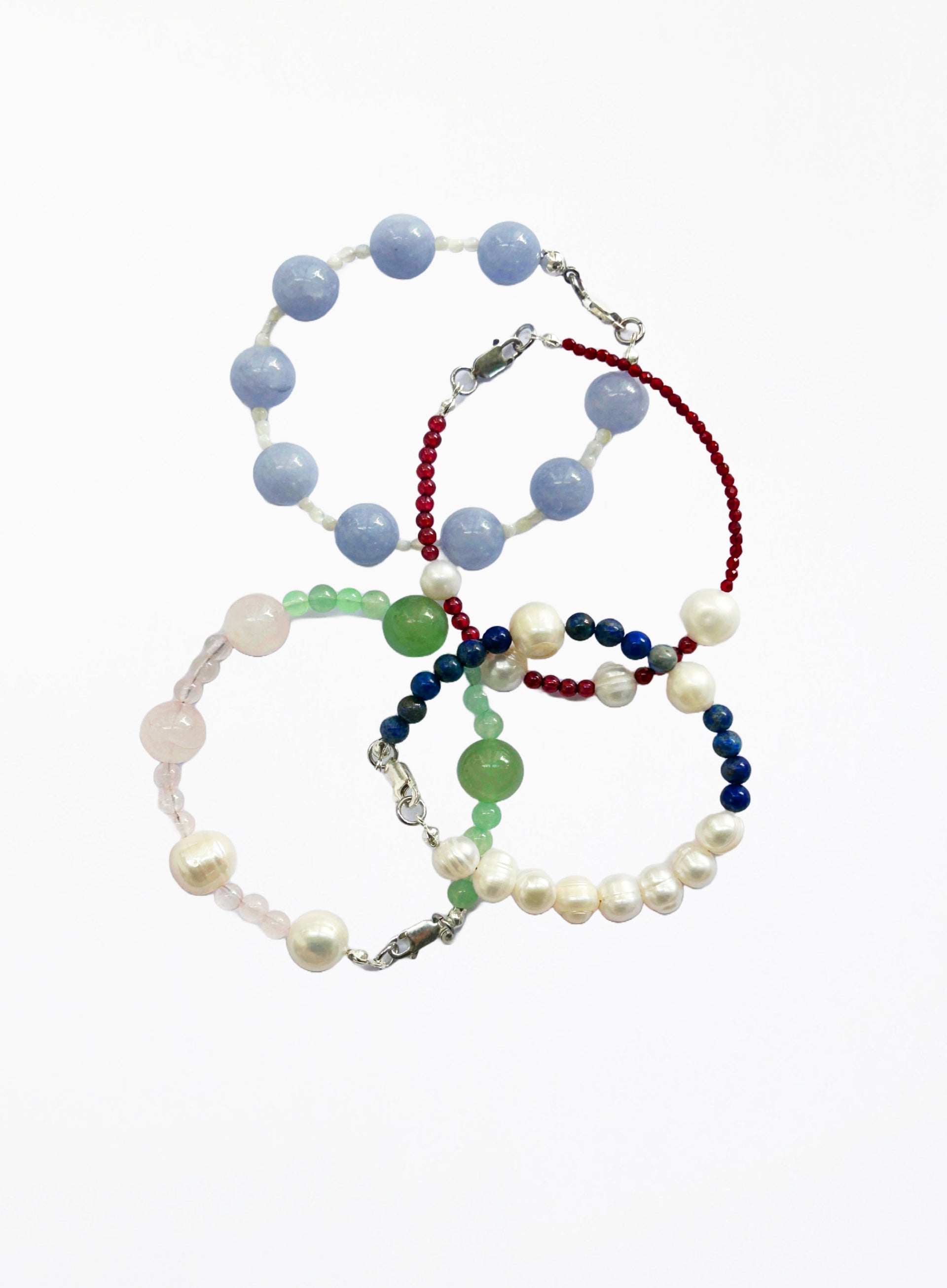 Set of four beaded bracelets on a white background