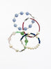 Set of four beaded bracelets on a white background