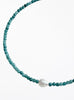 Turquoise beaded necklace with a pearl pendant on a white background