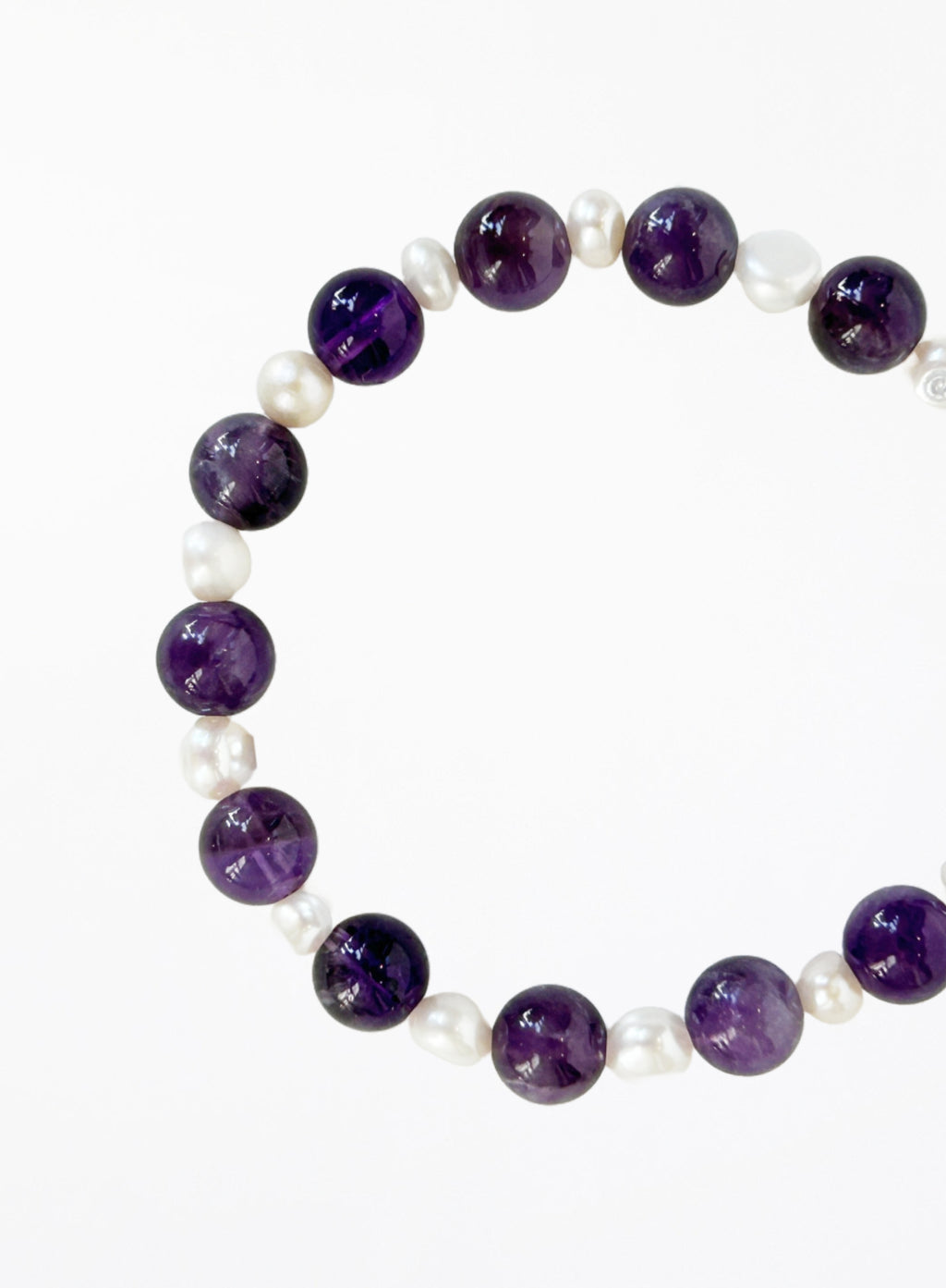 Bracelet with amethyst beads and pearls with silver clasp on a white background