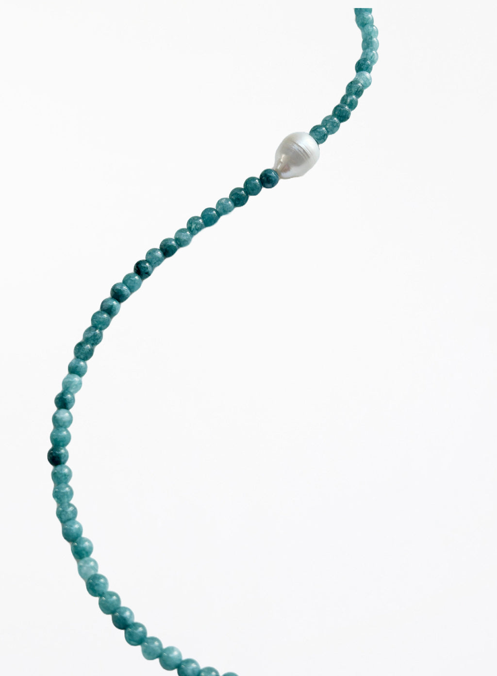 Turquoise beaded necklace with a pearl pendant on a white background