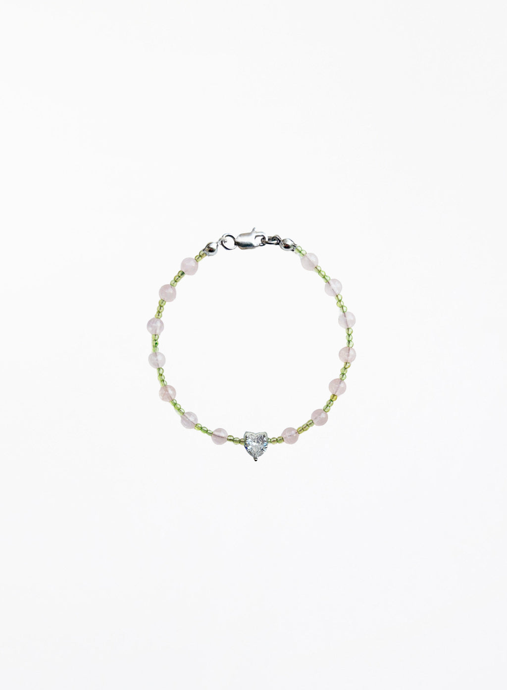 Bracelet with heart-shaped charm on a white background