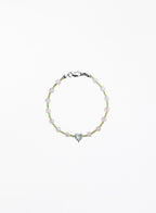 Bracelet with heart-shaped charm on a white background