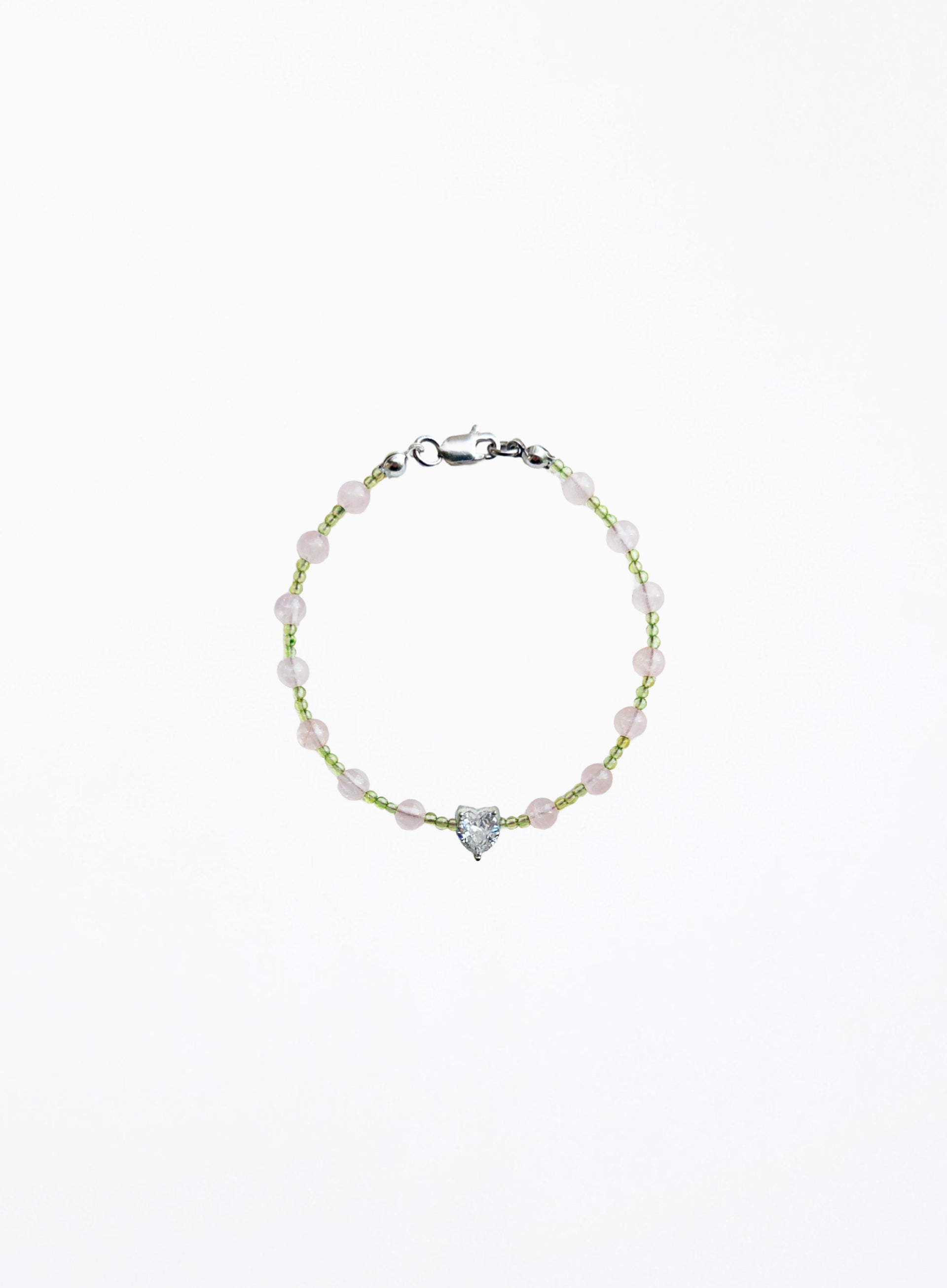 Bracelet with heart-shaped charm on a white background