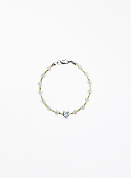 Bracelet with heart-shaped charm on a white background
