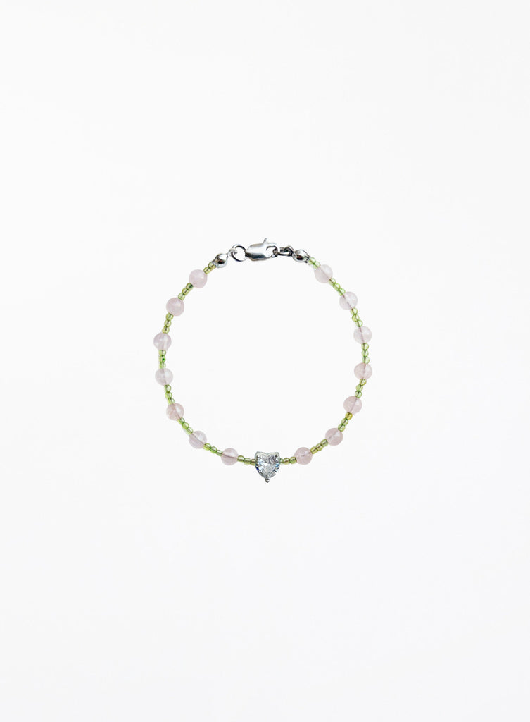 Bracelet with heart-shaped charm on a white background