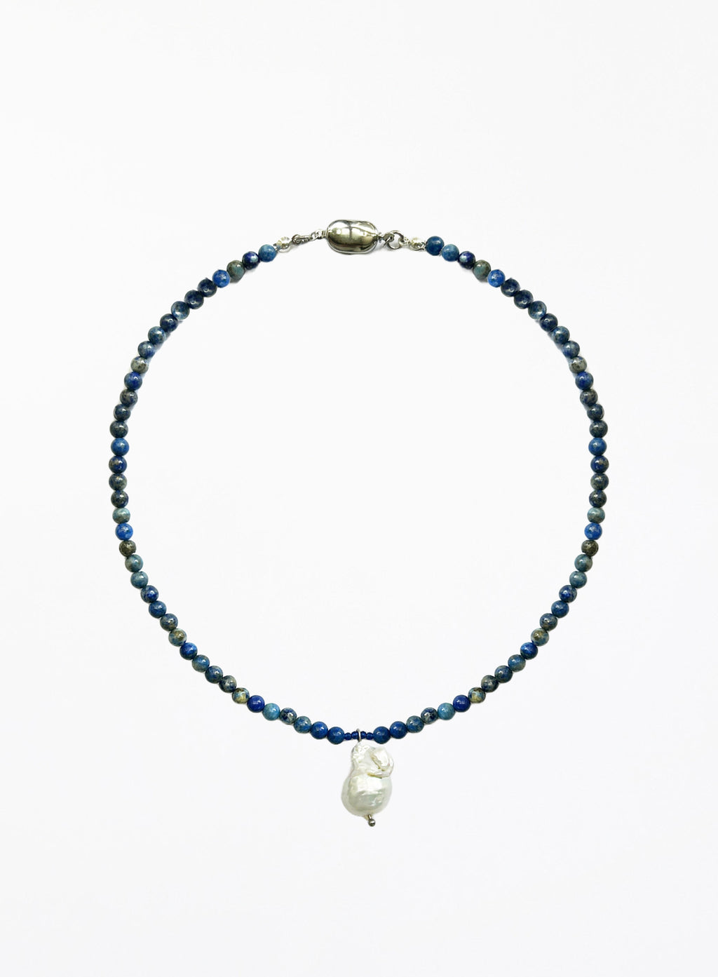 Necklace with blue beads and a white baroque pearl pendant on a white background