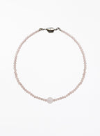 pink necklace on a white background