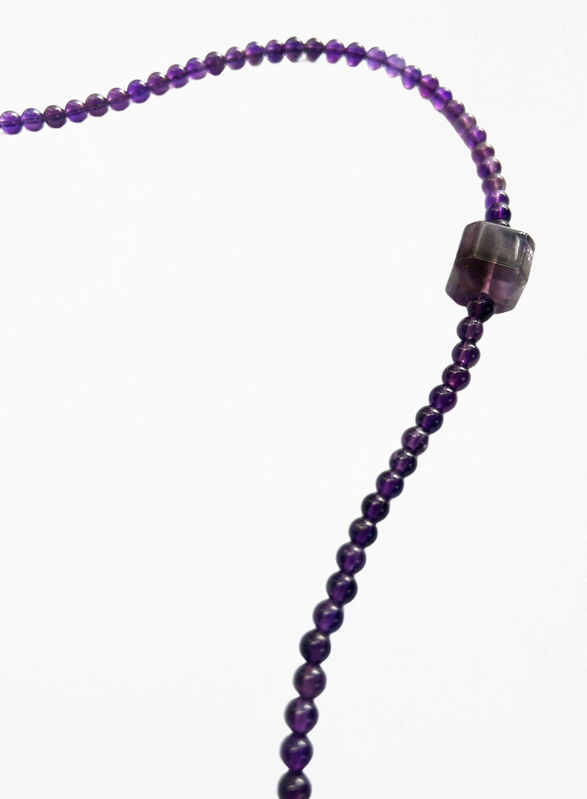 Purple amethyst necklace with square pendant on a white background