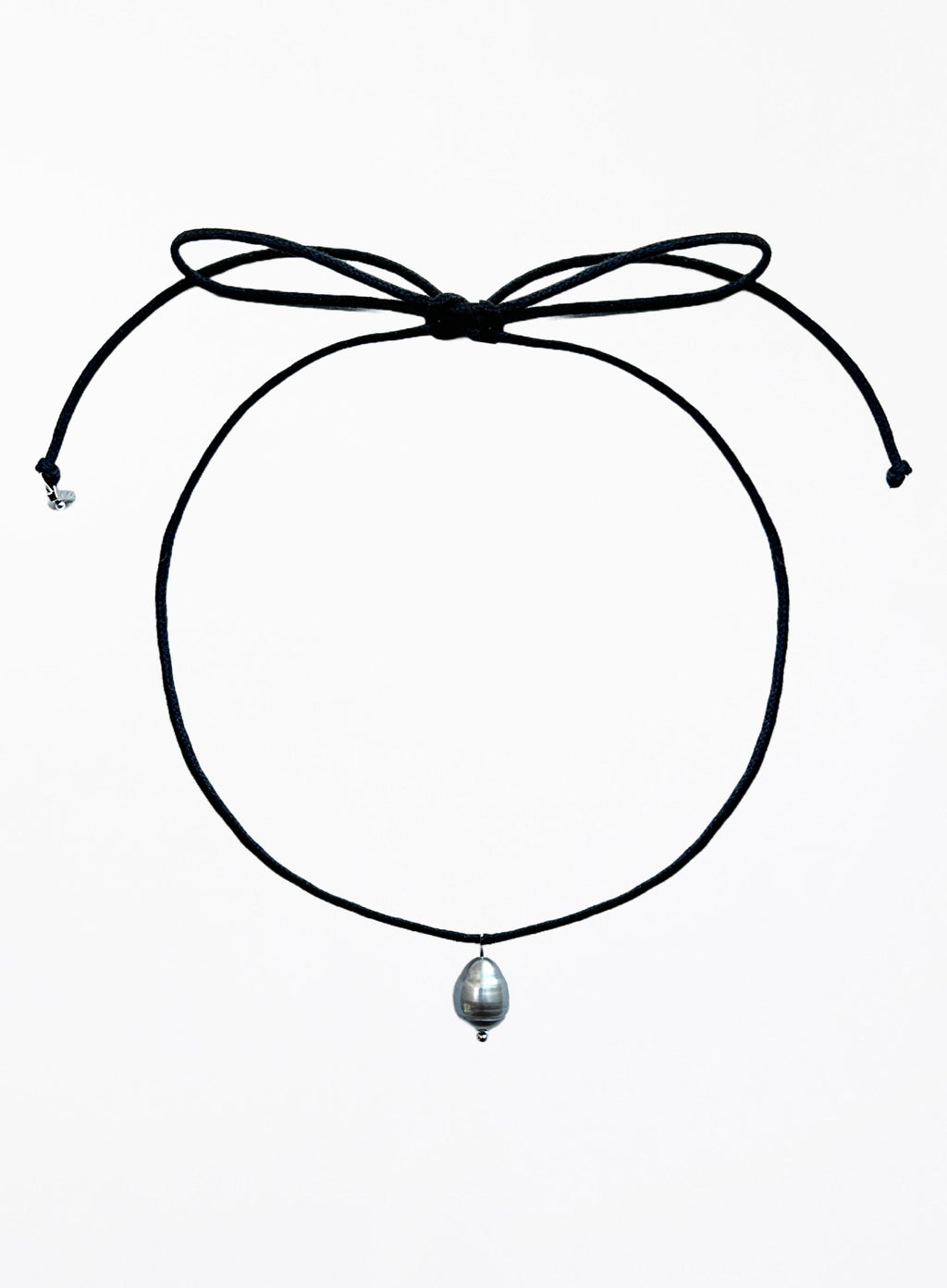Thin black choker necklace with a pearl pendant on a white background