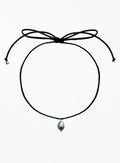 Thin black choker necklace with a pearl pendant on a white background