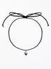 Thin black choker necklace with a pearl pendant on a white background