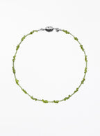 Green beaded necklace on a white background