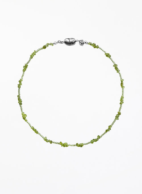 Green beaded necklace on a white background