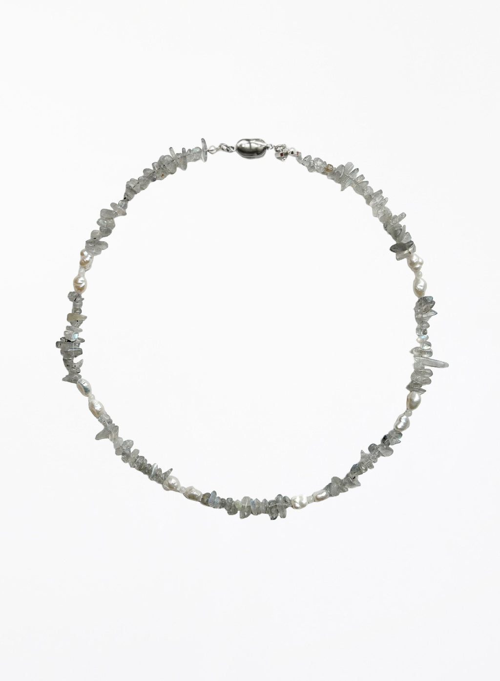 A delicate necklace made of small, irregular gray stone chips and white pearl beads, arranged in a circle on a plain white background.