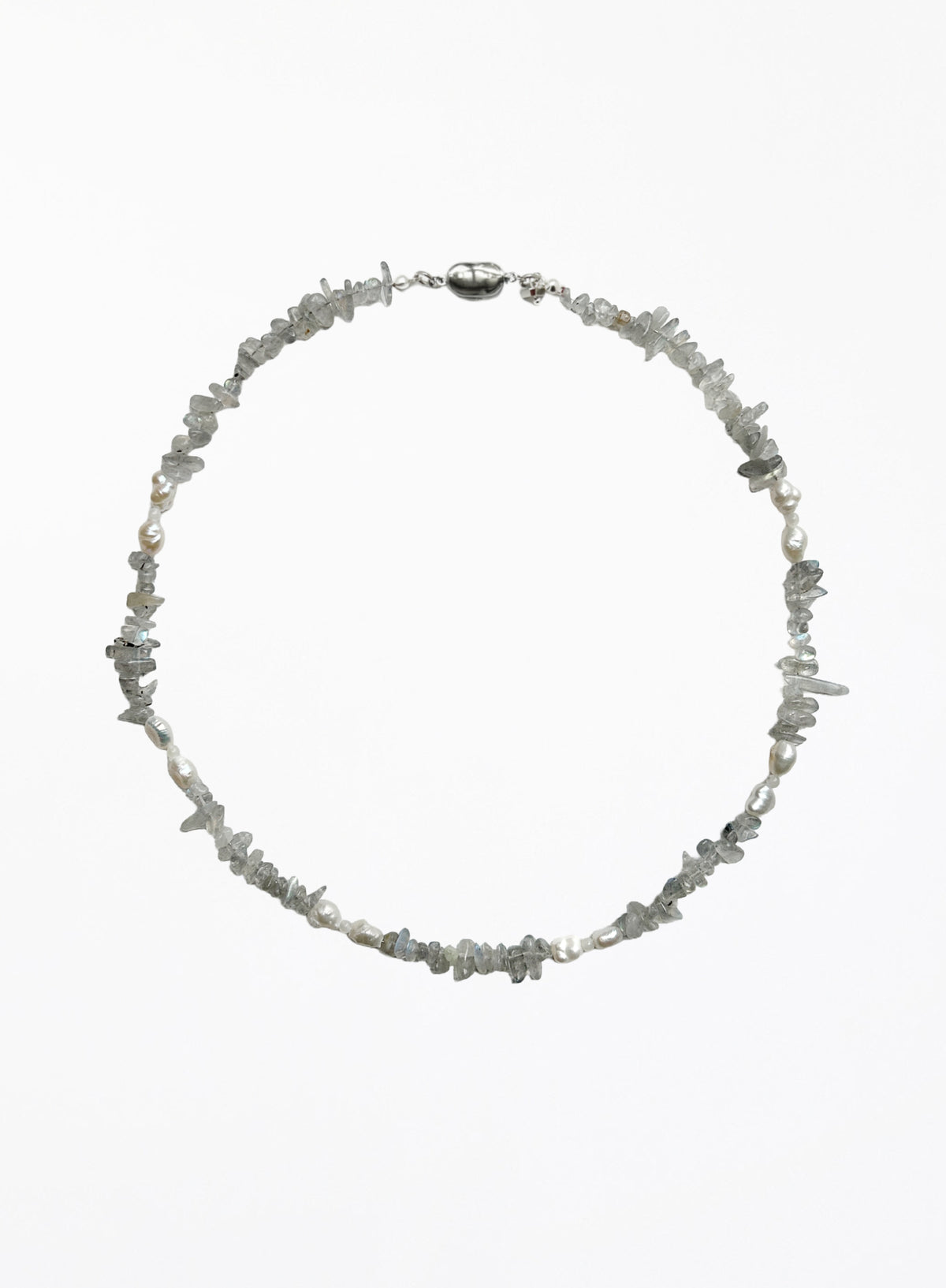 A delicate necklace made of small, irregular gray stone chips and white pearl beads, arranged in a circle on a plain white background.