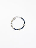 Pearl and navy bead bracelet on a white background