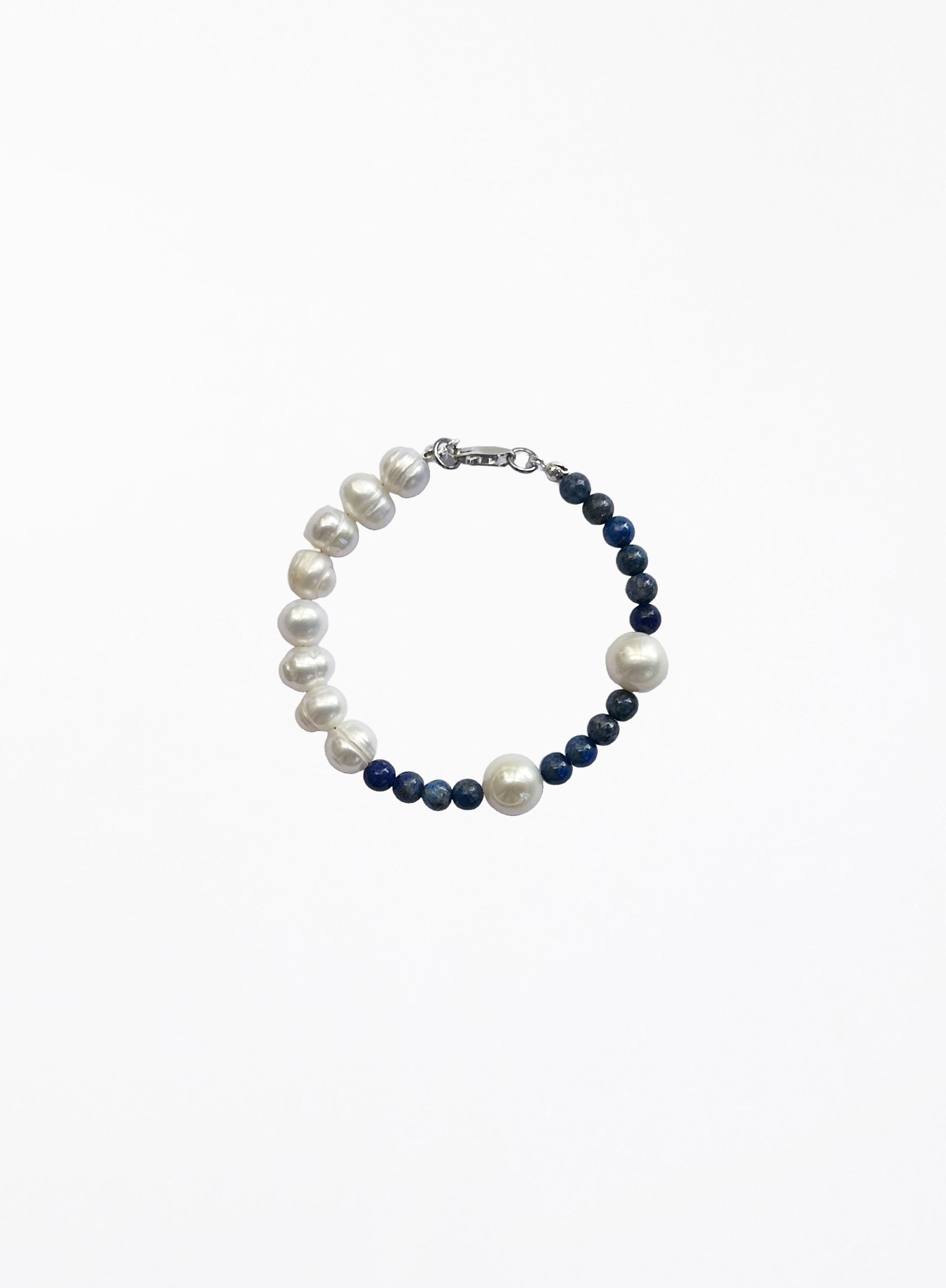Pearl and navy bead bracelet on a white background