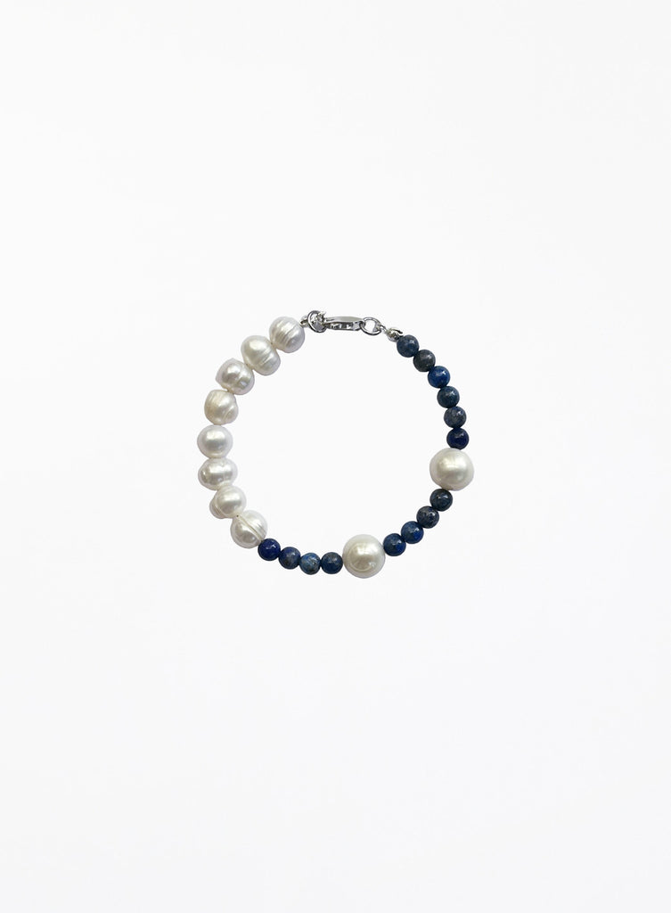 Pearl and navy bead bracelet on a white background