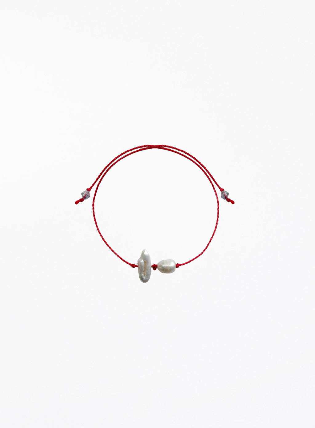 Red cord bracelet with two pearls on a white background