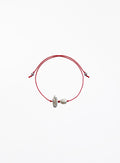 Red cord bracelet with two pearls on a white background