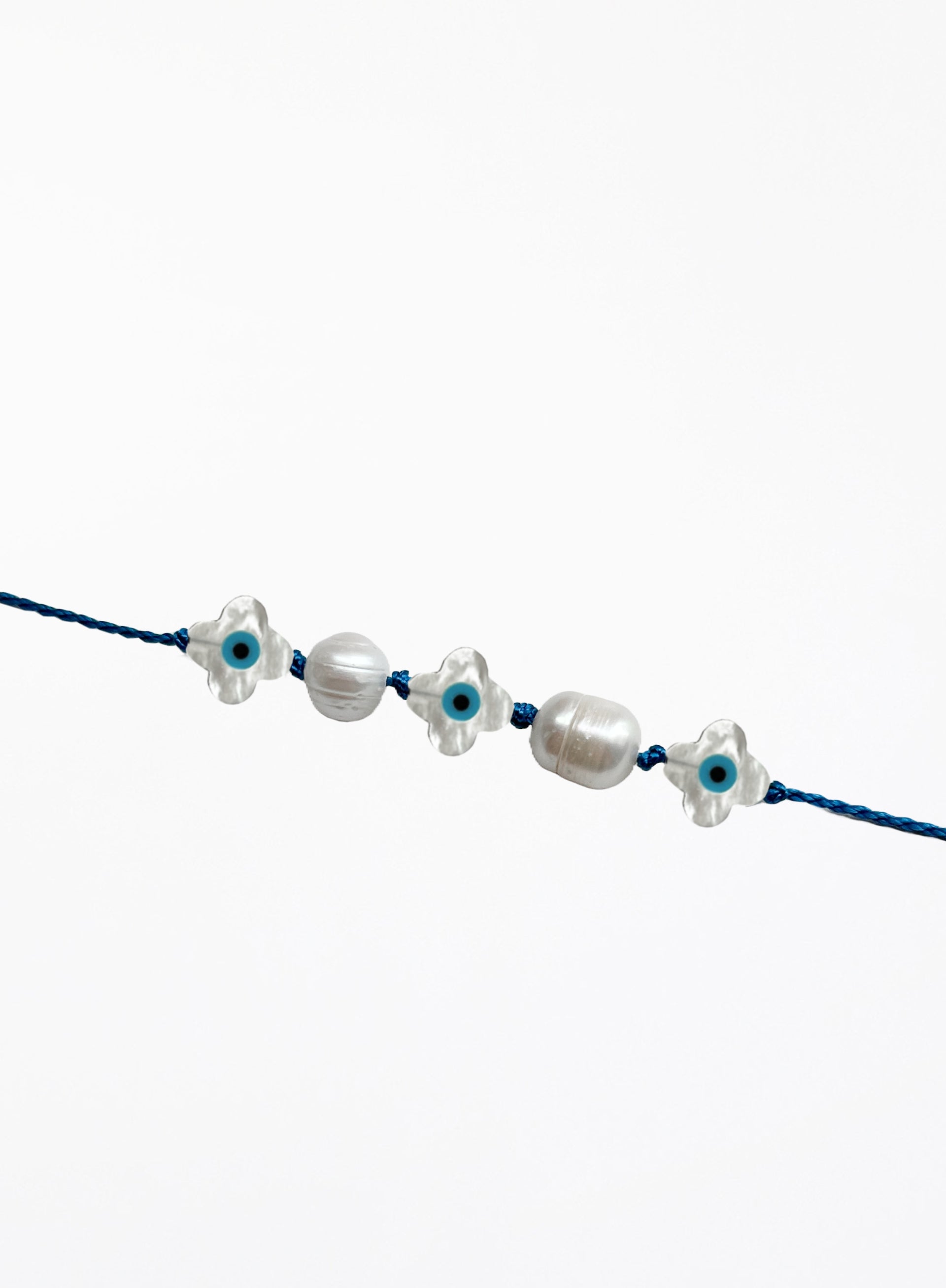 blue silk cord bracelet with eveil eye beads and pearls